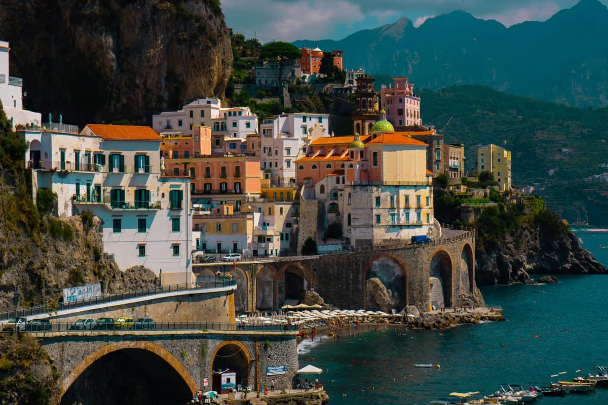 The village of Atrani with houses built over the arches of the coast road beside the sea