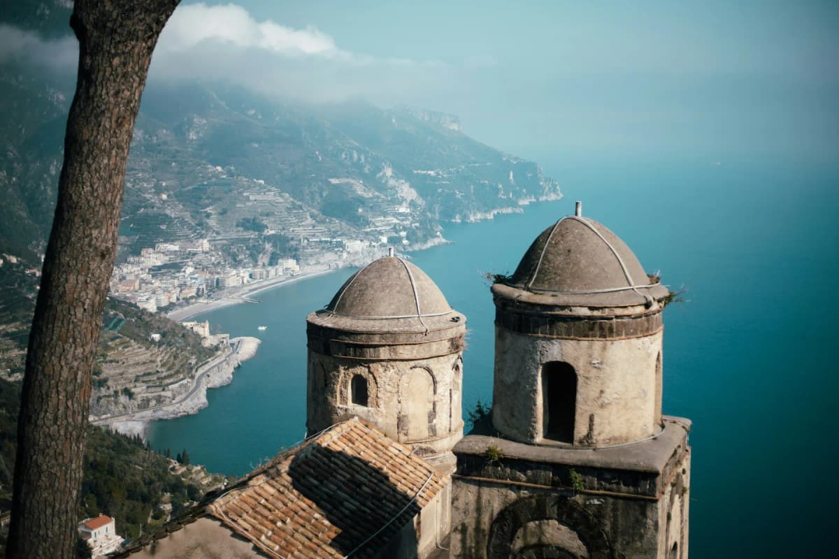 The twin domes of Villa Rufolo in Ravello with the Amalfi Coast far below