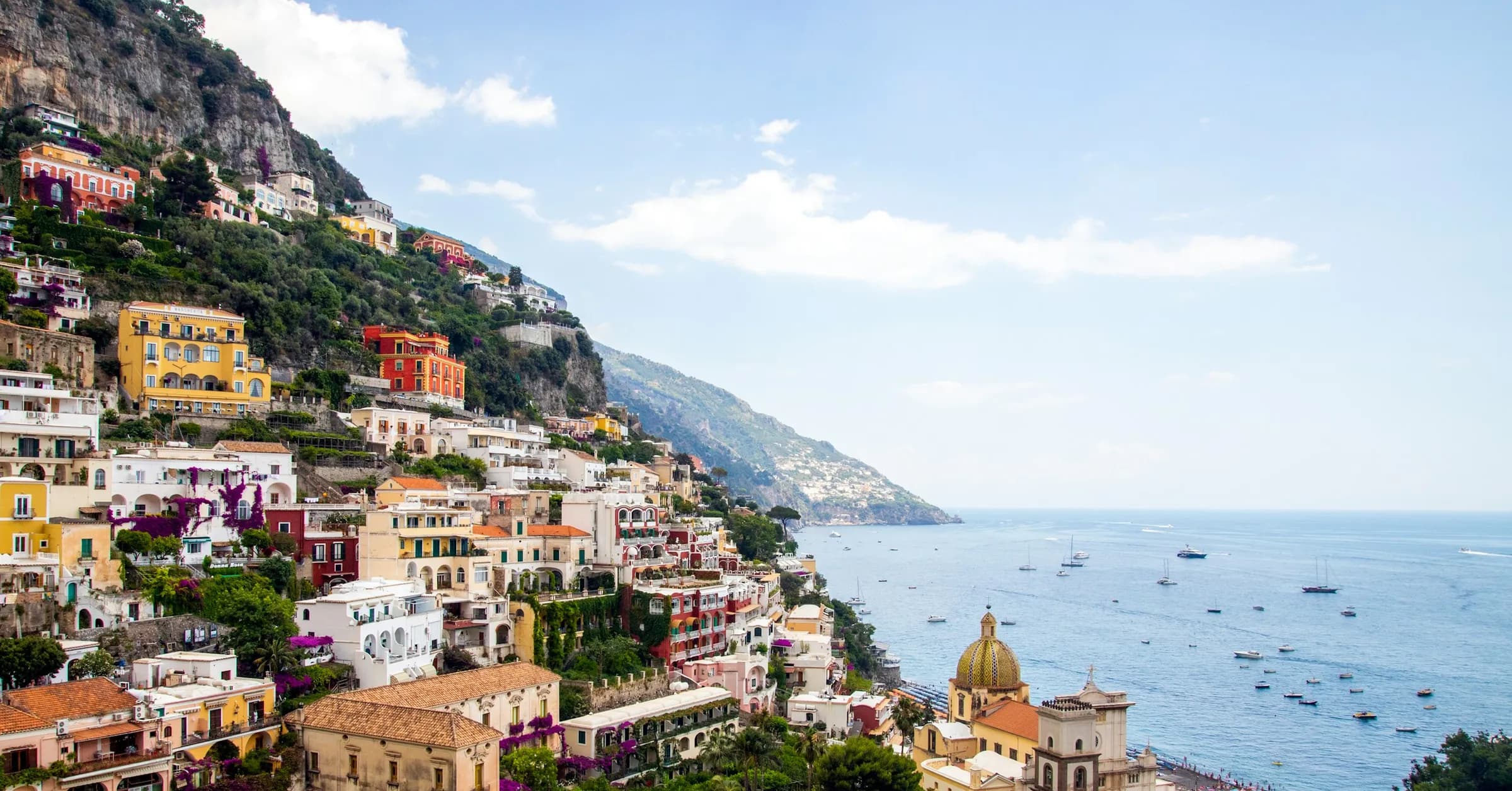 Amalfi Coast itinerary: the pastel houses of Positano stacked on a steep hillside above the sea