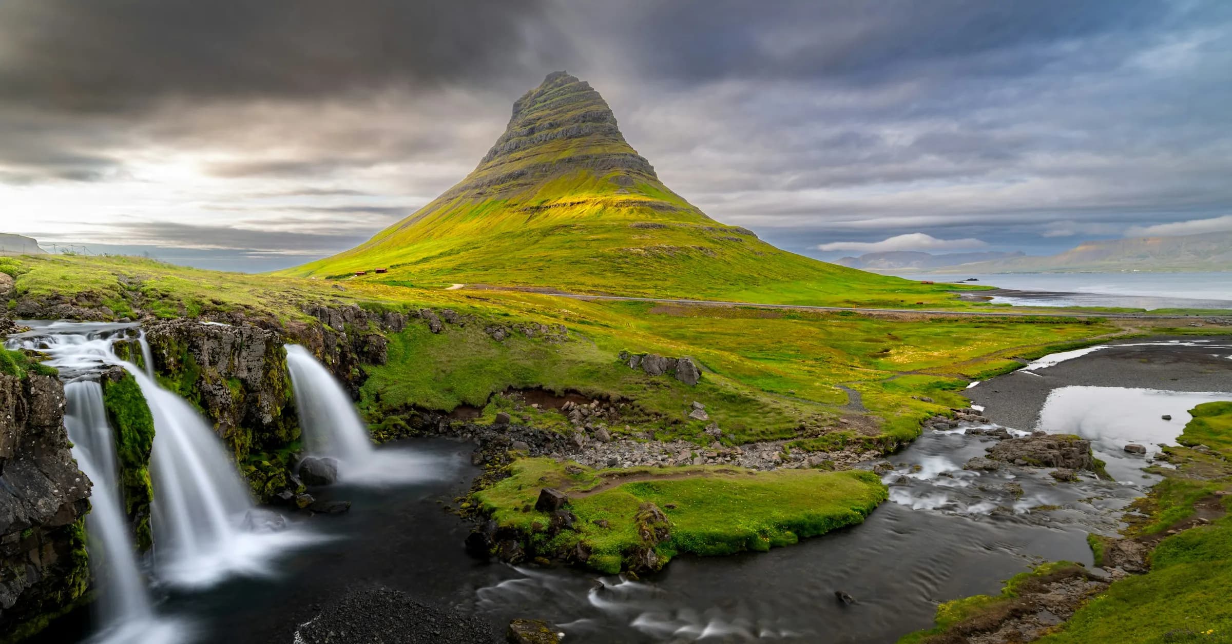 Best places to visit in Iceland: Kirkjufell mountain rising behind the Kirkjufellsfoss waterfall on the Snæfellsnes Peninsula