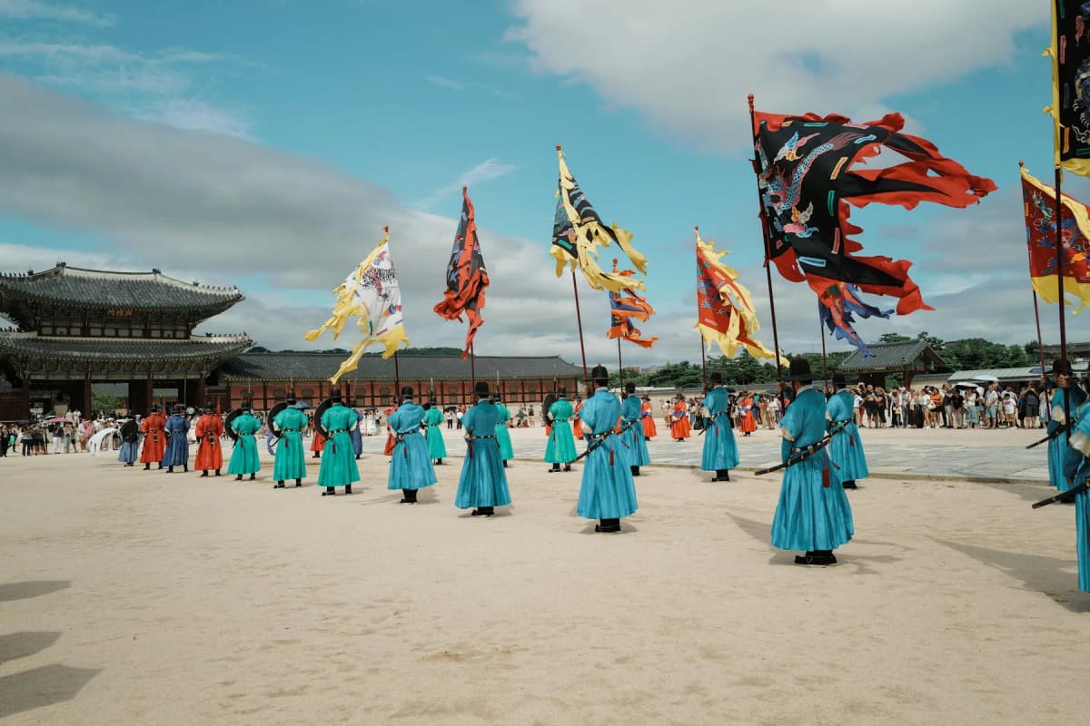 Royal guards in red and blue uniforms during the changing of the guard ceremony at Gyeongbokgung Palace