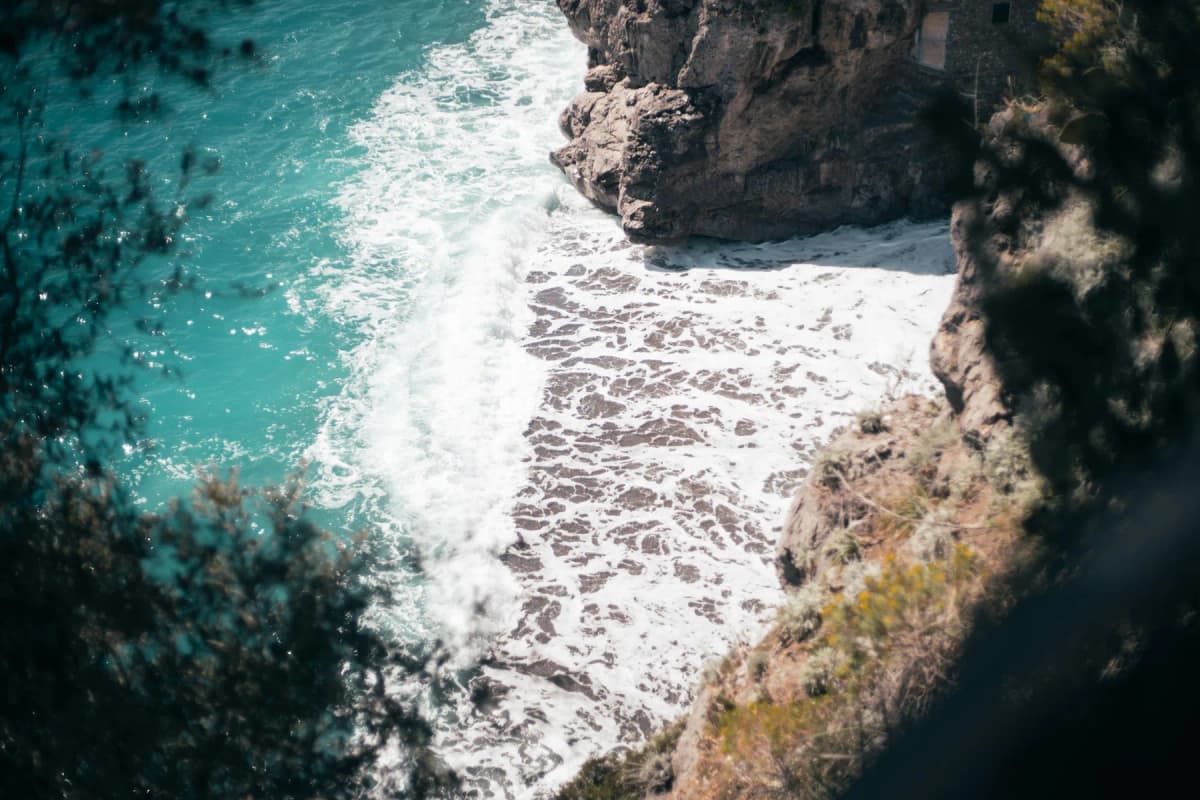 Waves breaking into a rocky cove seen from above on a rough day