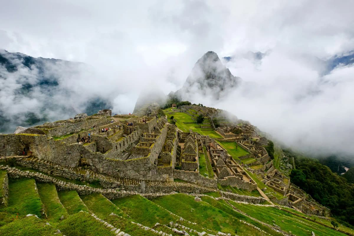 Clouds drifting across the terraces of Machu Picchu with Huayna Picchu half hidden