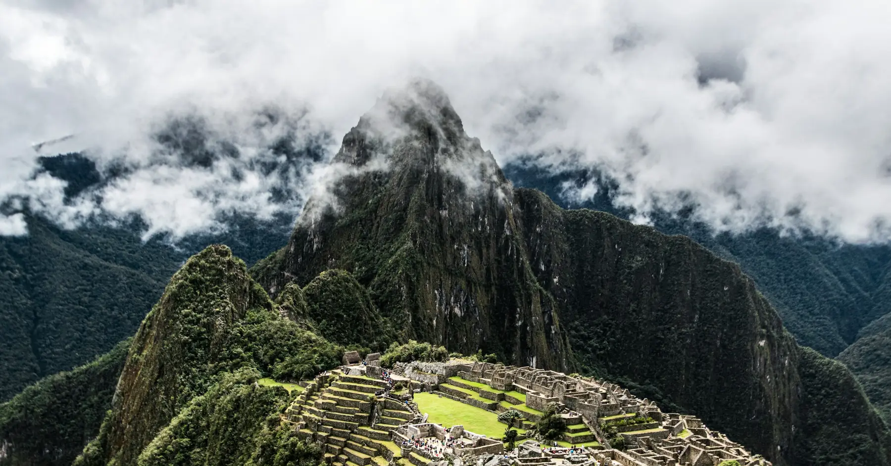 Best time to visit Machu Picchu: the ruins below Huayna Picchu, with clouds drifting over the peaks