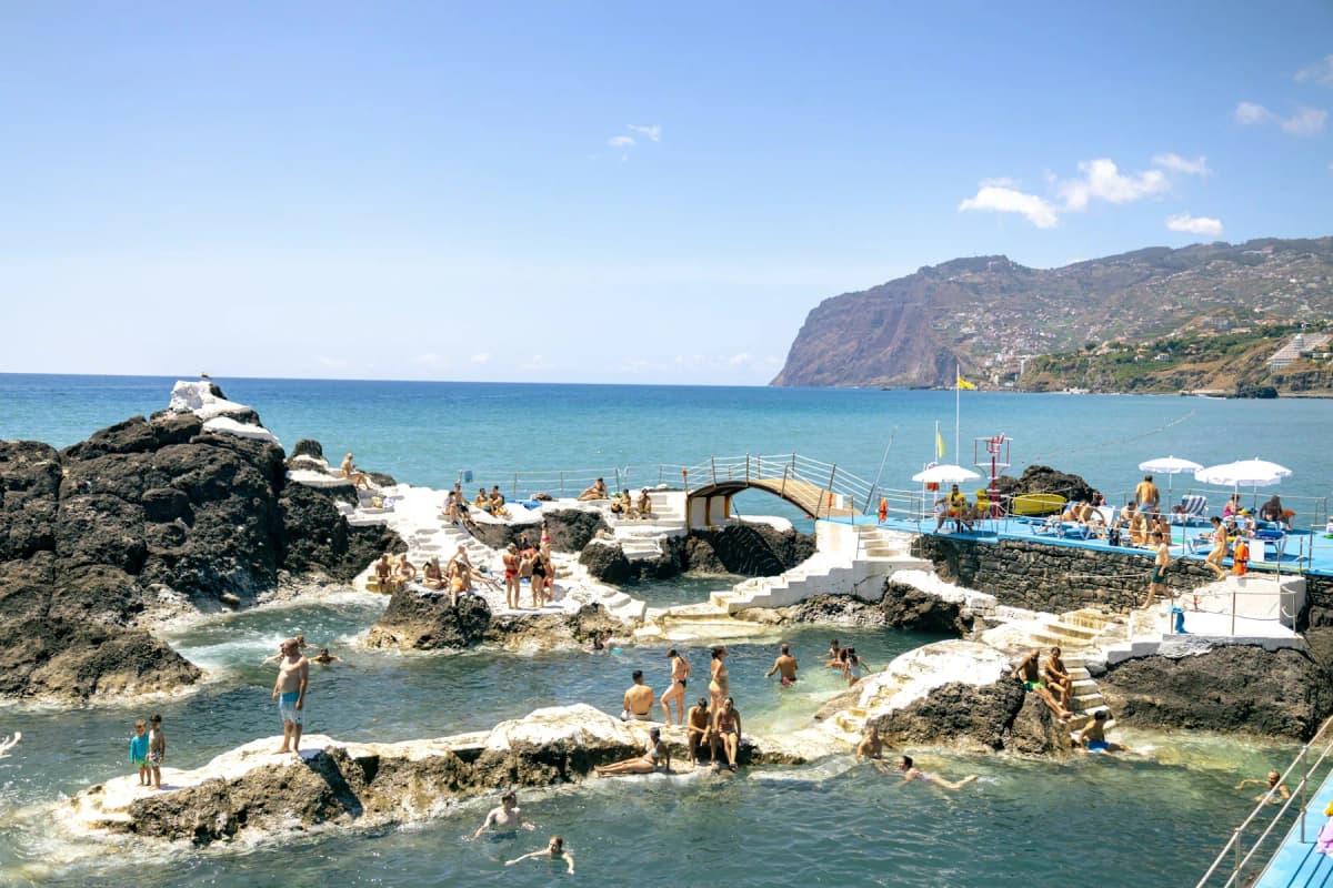 Swimmers in a sea-water pool beside the ocean in Funchal on a sunny day