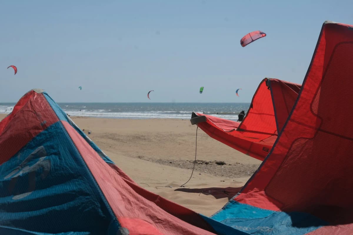 Kites on the wide sandy beach at Essaouira, where summer highs stay near 22°C