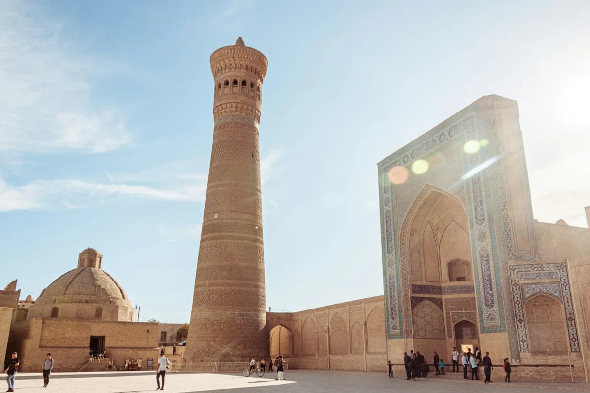 The Kalyan Minaret and Mir-i-Arab Madrasa in Bukhara on a sunny afternoon