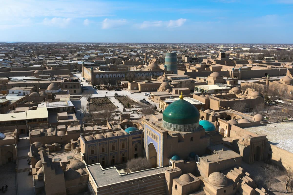 Mud-brick houses and turquoise domes seen from above inside Khiva's Itchan Kala