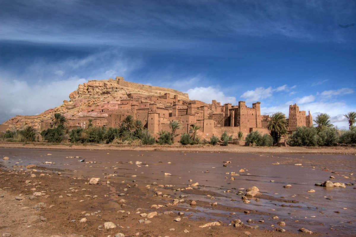 The earthen ksar of Aït Benhaddou rising above a dry riverbed
