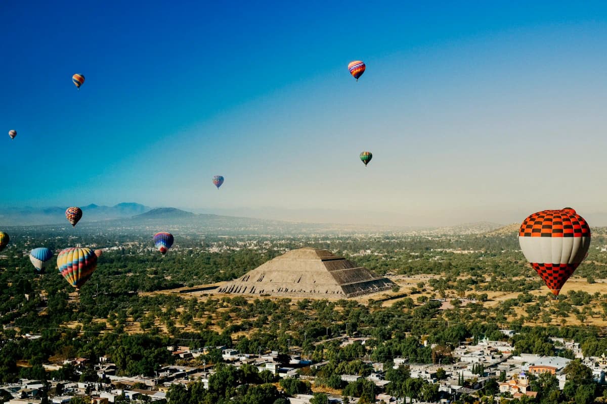 Hot-air balloons at sunrise over the Pyramid of the Sun at Teotihuacan