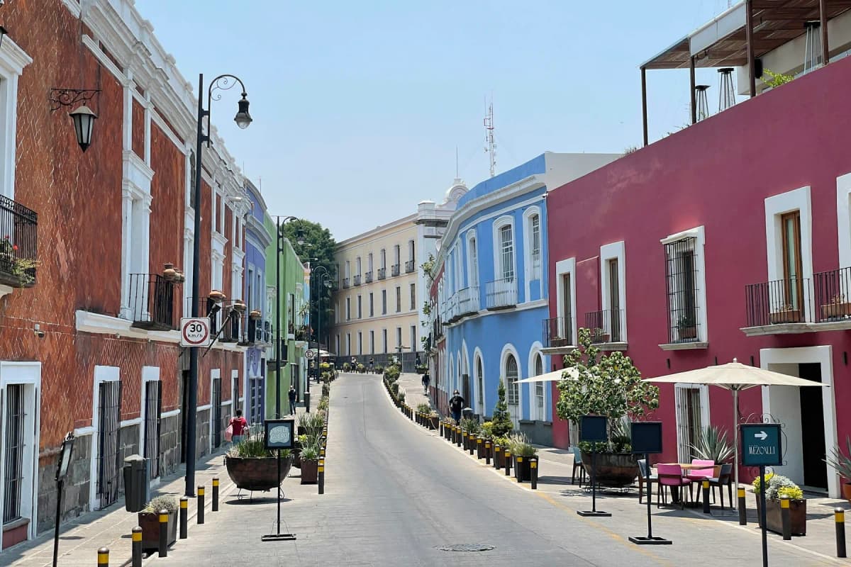 A colourful street of painted buildings in Puebla