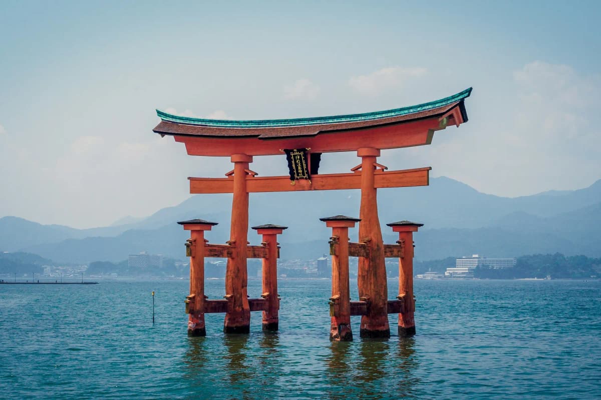 The orange torii gate of Itsukushima Shrine standing in the sea off Miyajima