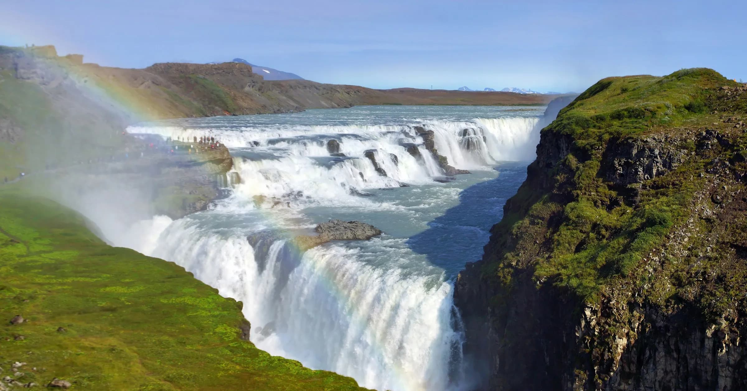 Day trips from Reykjavik: the Gullfoss waterfall tumbling into a canyon with a rainbow in the spray