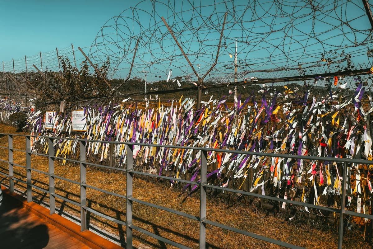 Hundreds of colourful ribbons tied to a barbed-wire fence near Imjingak in Paju