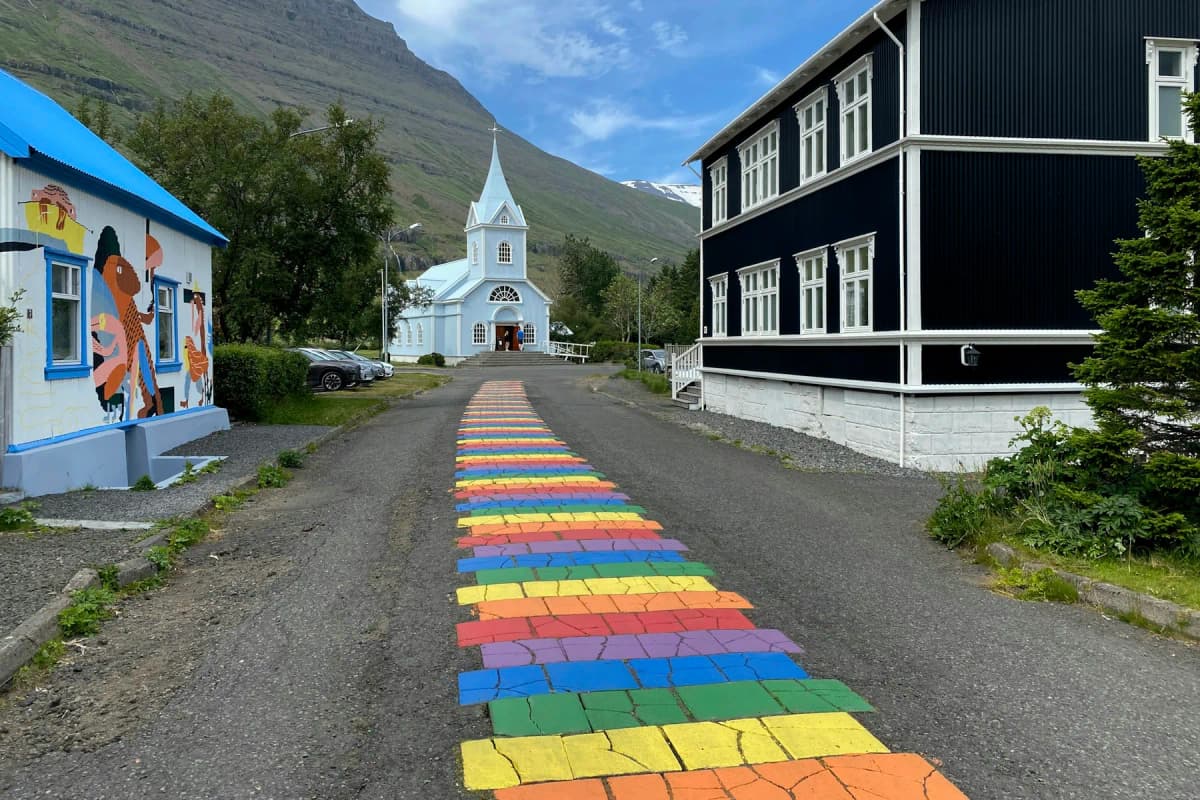 Best places to visit in Iceland: colourful wooden houses beneath snowy mountains in the Eastfjords village of Seyðisfjörður