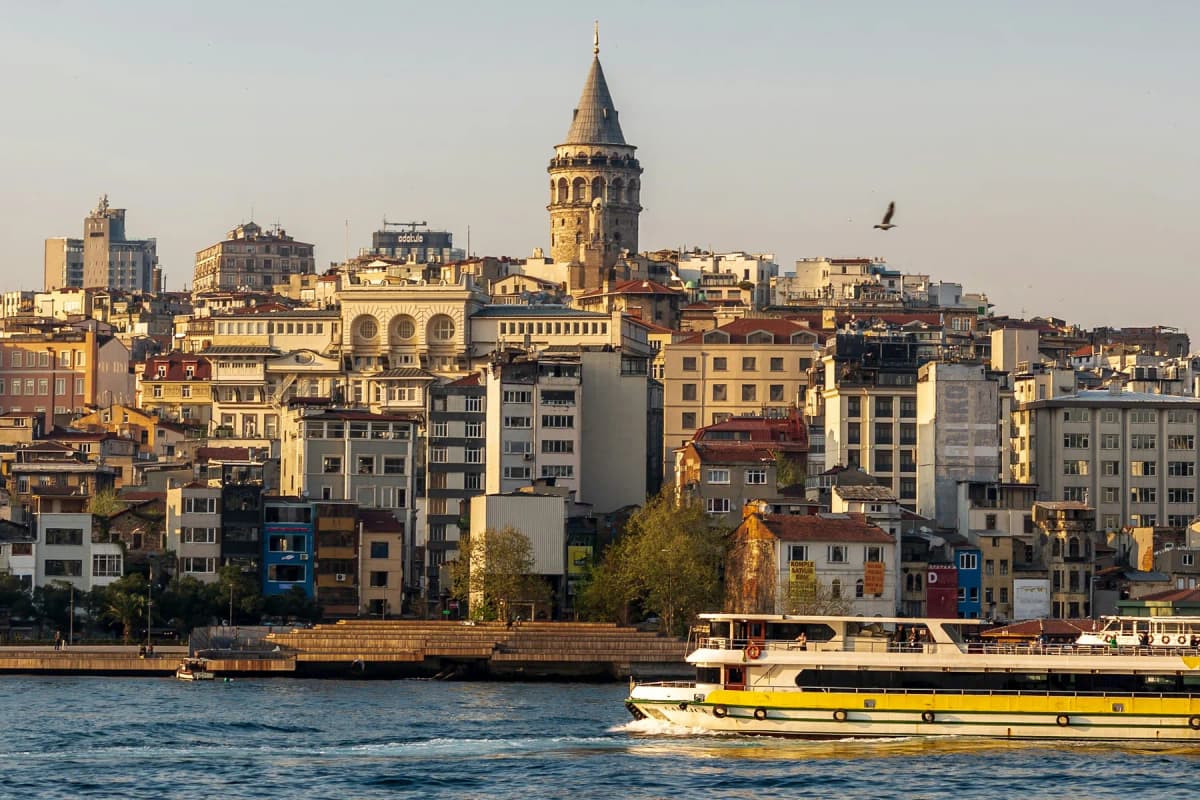 A ferry passing the Galata waterfront with the Galata Tower above