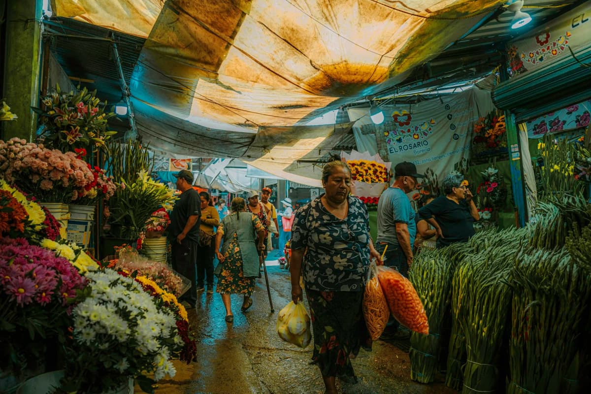 Shoppers choosing flowers at a busy market in Mexico City