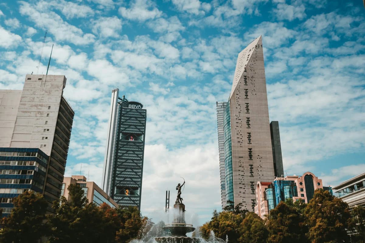 Towers along Paseo de la Reforma in Mexico City under a blue sky