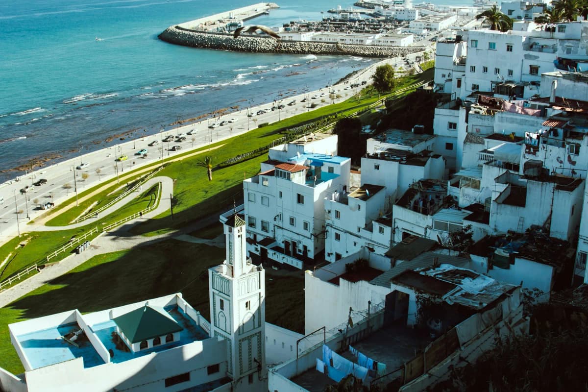 White houses of Tangier above the city beach and the breakwater of the port