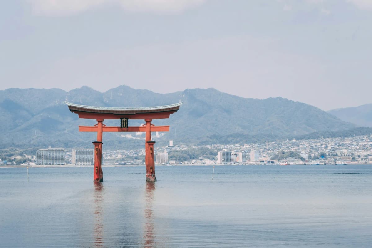 The red torii gate of Itsukushima Shrine standing in the sea at Miyajima