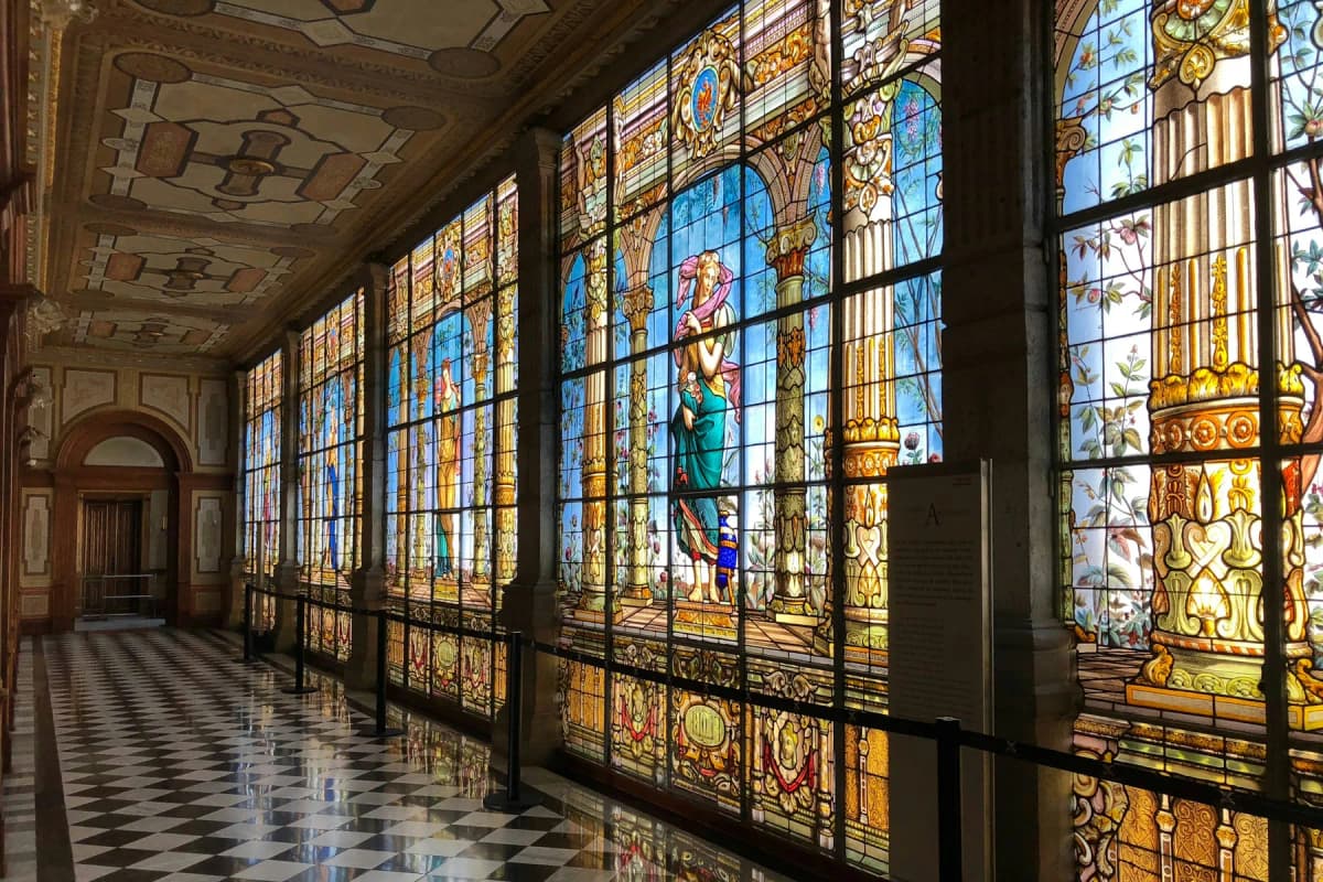 The stained-glass gallery with a checkered floor inside Chapultepec Castle