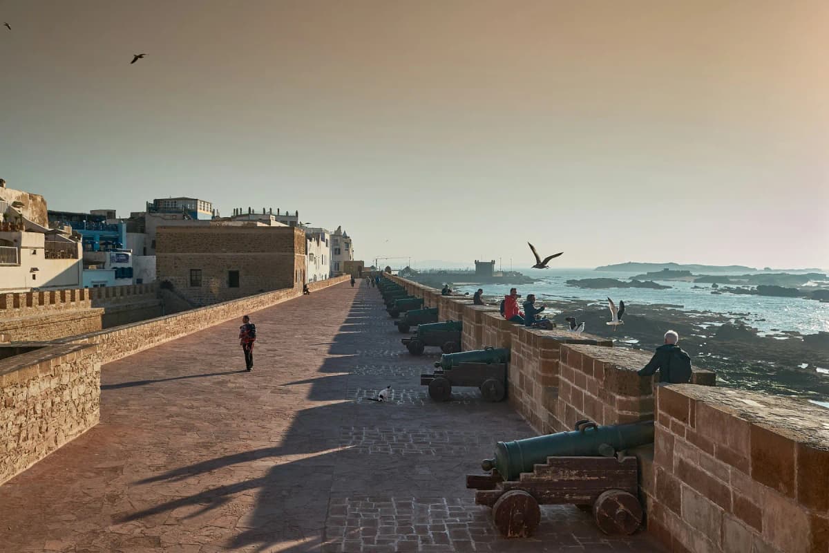 The stone sea ramparts of Essaouira with a row of old cannons facing the Atlantic