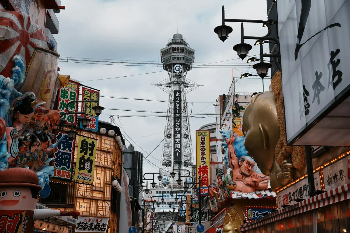 Tsutenkaku tower rising above the signs and shopfronts of the Shinsekai district in Osaka