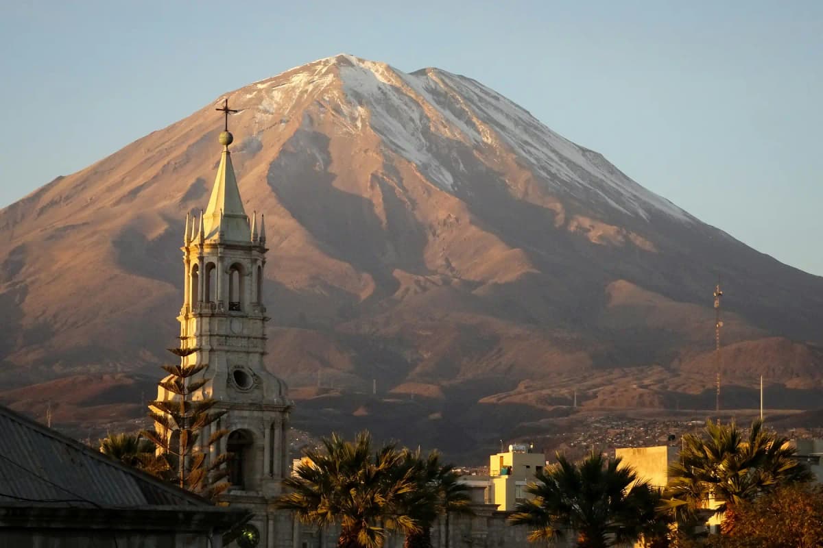 The El Misti volcano rising behind a church spire in Arequipa