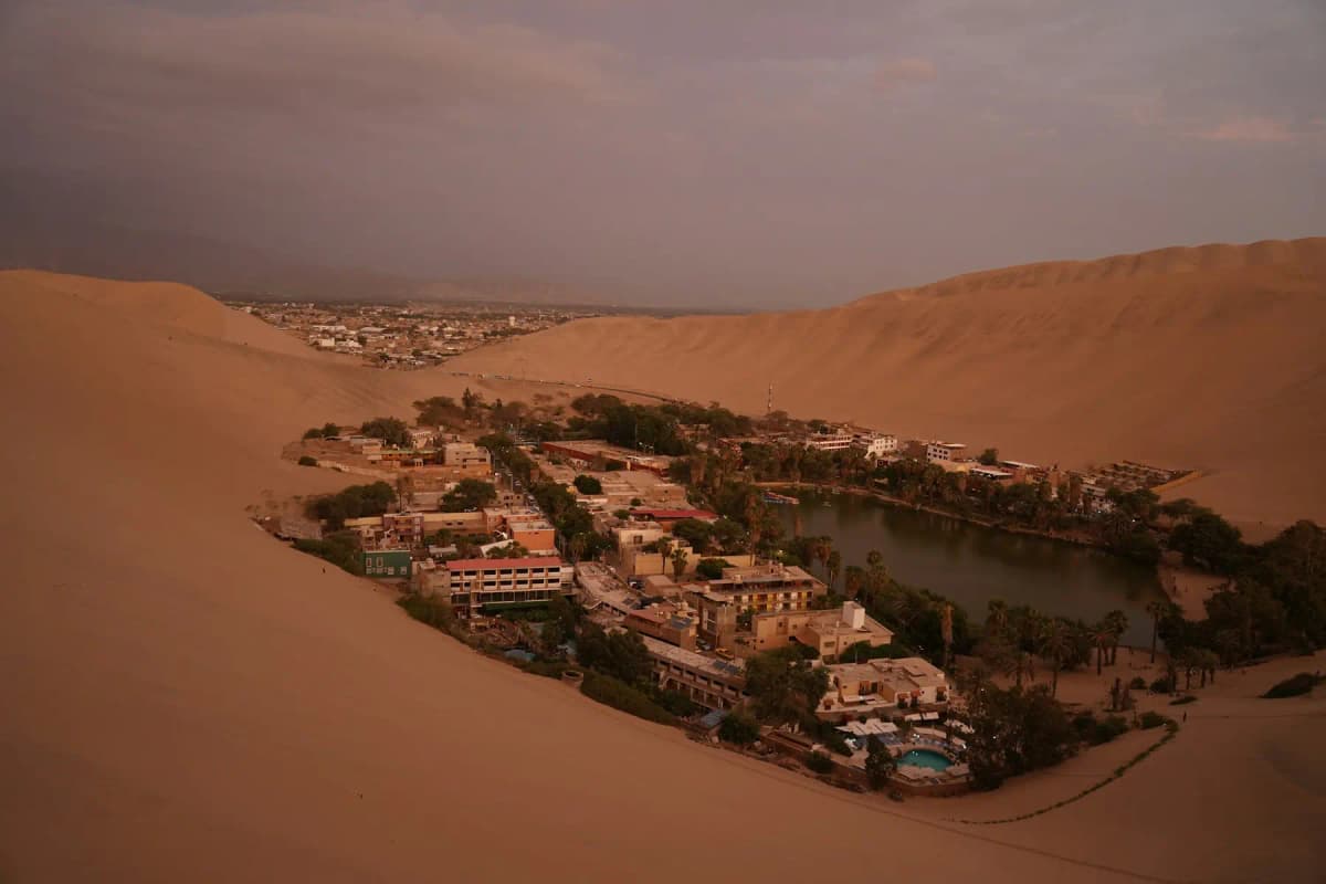The Huacachina oasis surrounded by huge sand dunes near Ica