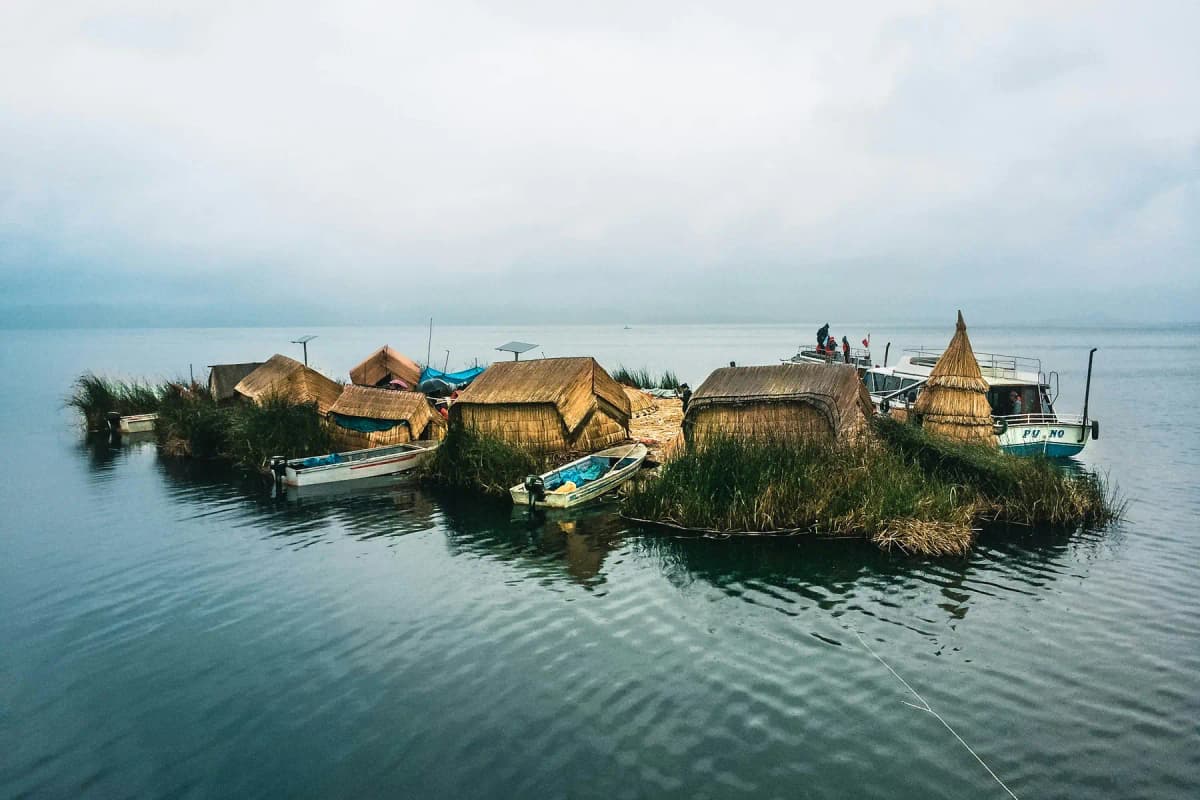 Reed houses and boats on a floating island of the Uros on Lake Titicaca