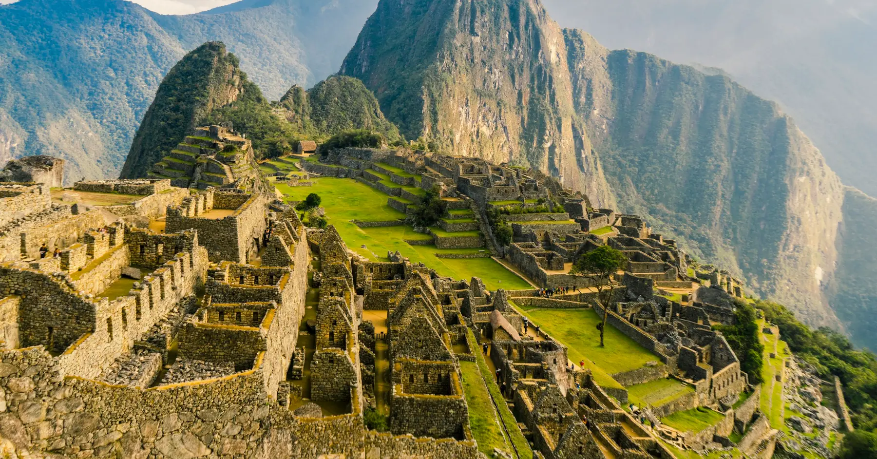 Peru itinerary: the ancient city of Machu Picchu with Huayna Picchu rising behind it