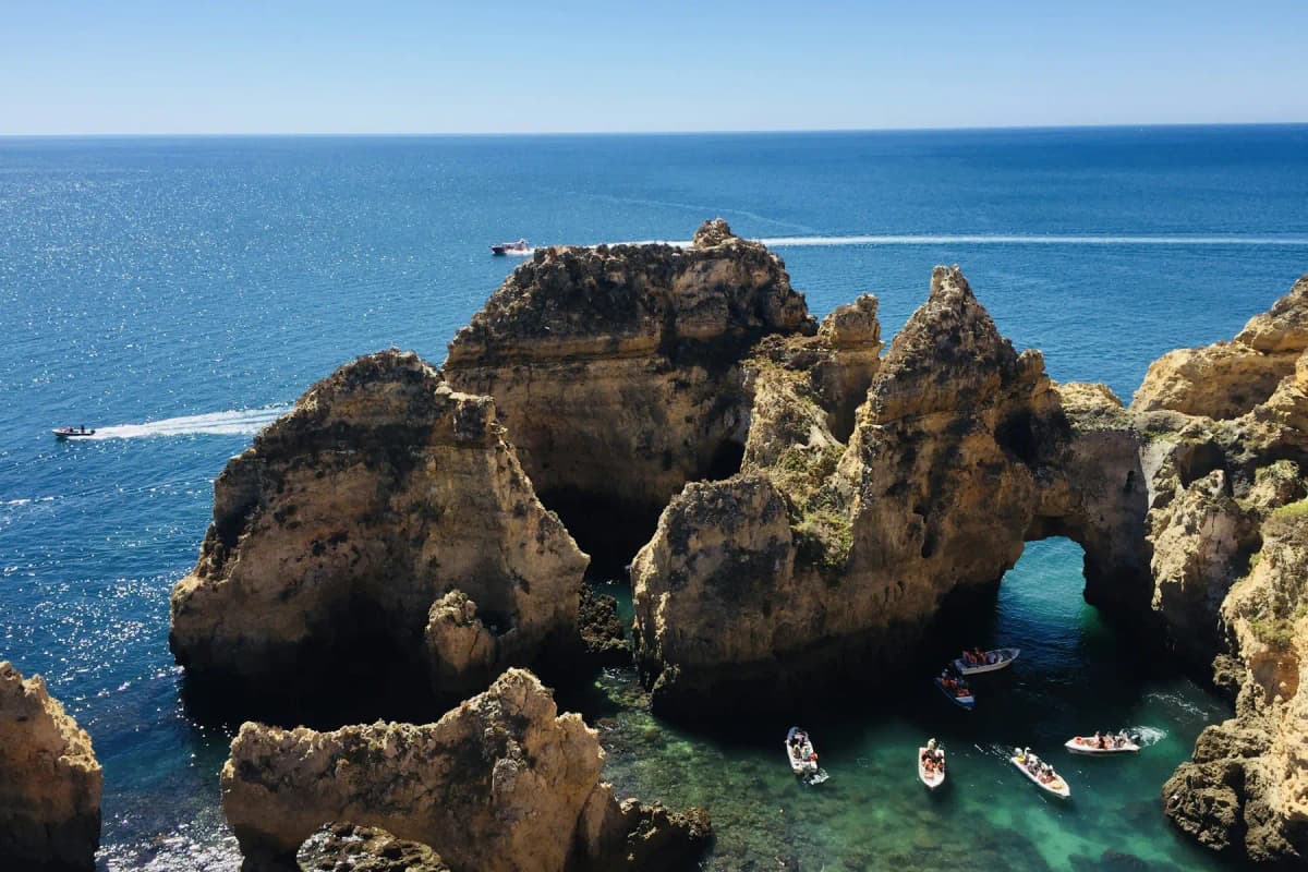 The sea stacks and arches of Ponta da Piedade near Lagos in the Algarve, with small boats in the water