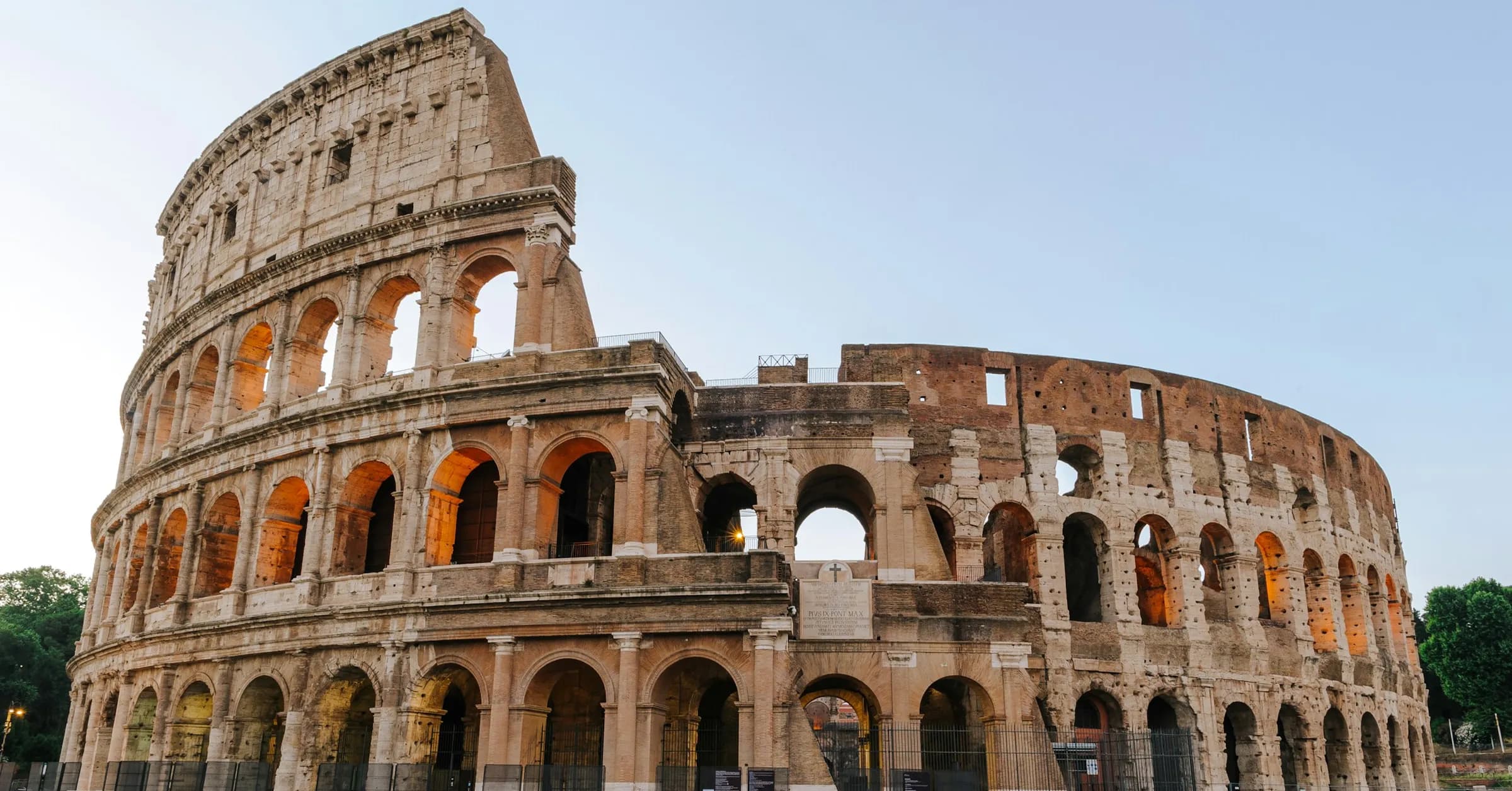 Rome itinerary: the Colosseum in warm evening light under a clear sky