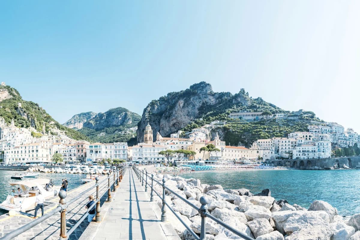 The long stone pier at Amalfi leading towards the town and the mountains