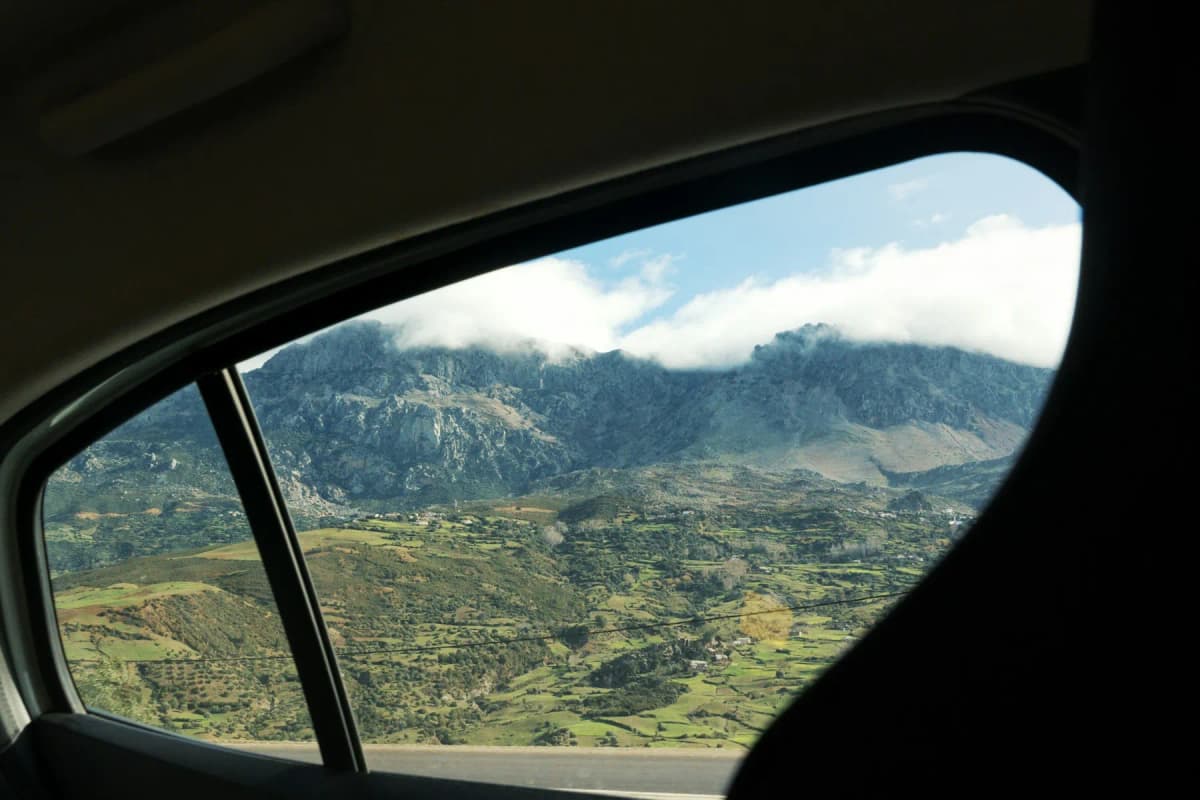The Rif mountains under low cloud seen through a car window on the road to Chefchaouen