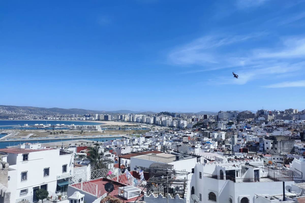 White rooftops of Tangier with the bay and the modern city behind, the starting point for the trip from Tangier to Chefchaouen