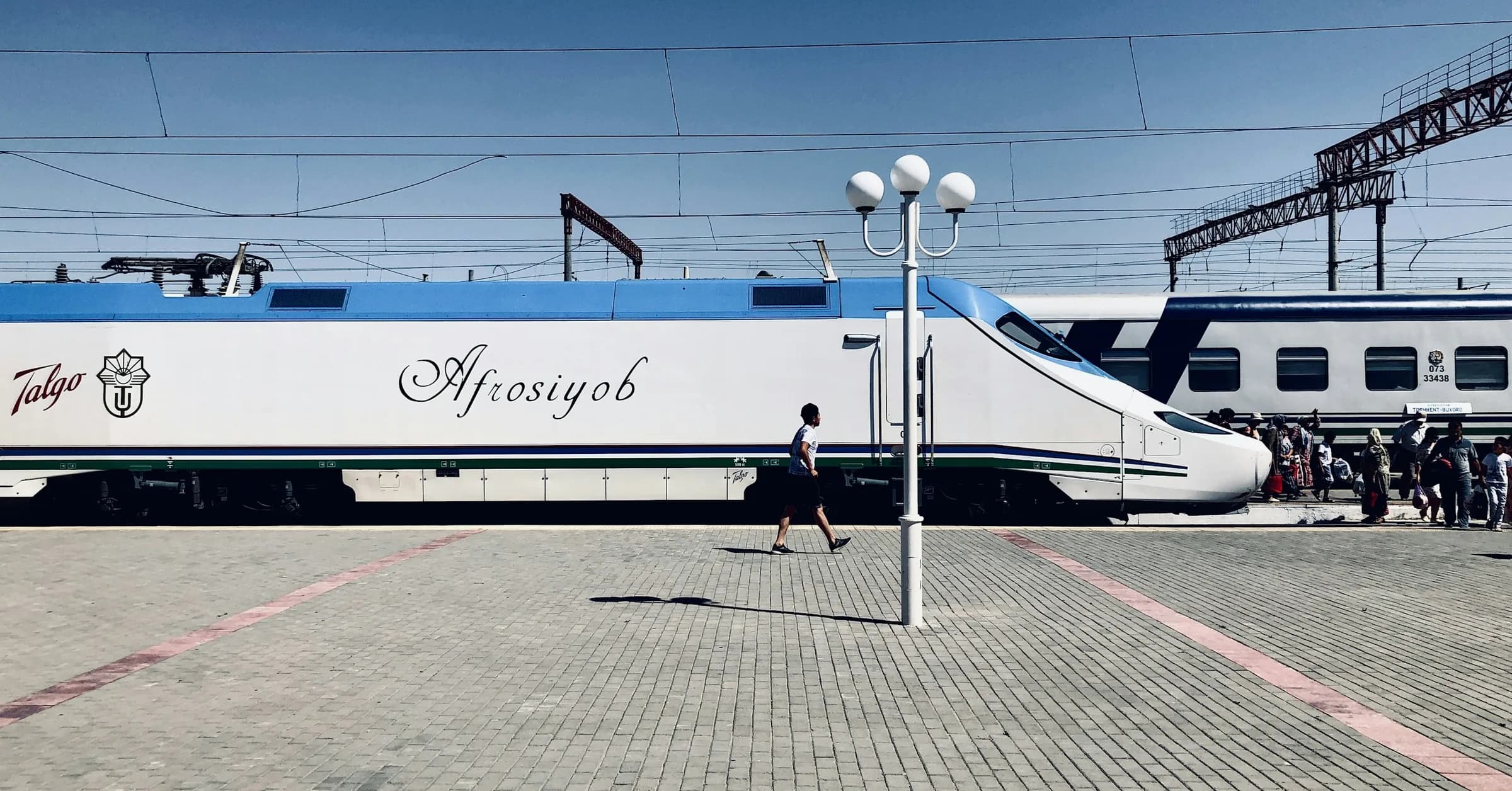 Tashkent to Samarkand: a white Afrosiyob high-speed train waiting at a station platform in Uzbekistan