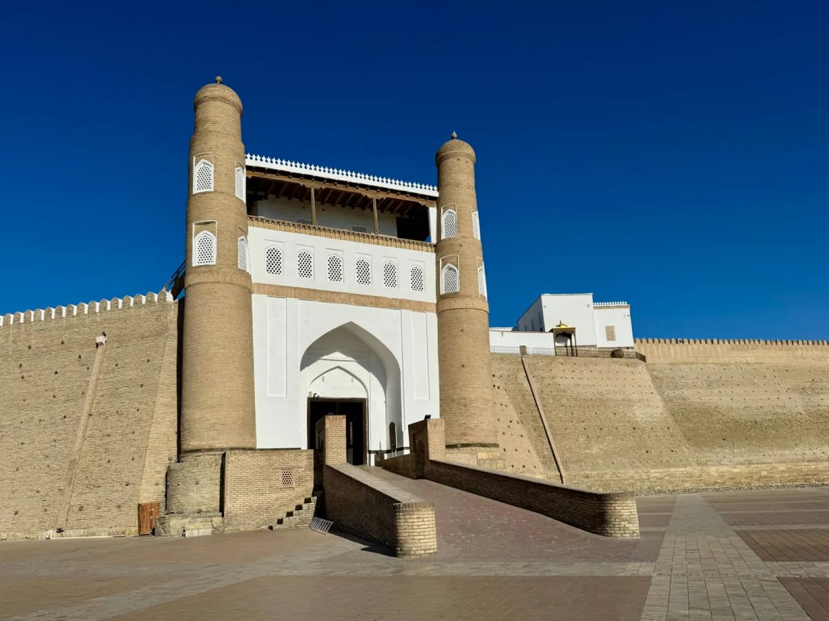 Things to do in Bukhara: the main gate of the Ark fortress, flanked by two towers above a long ramp