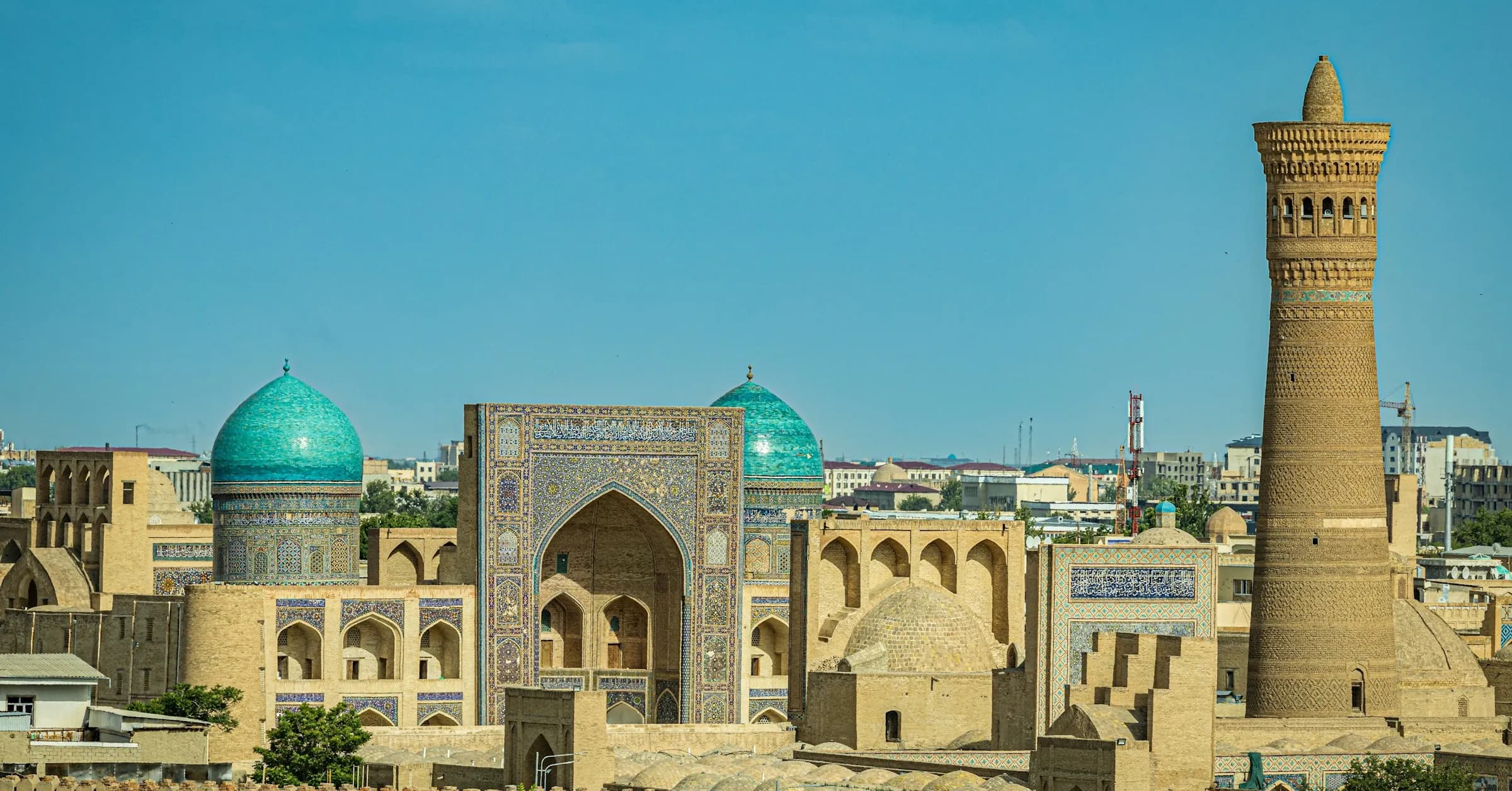 Things to do in Bukhara: the old city's turquoise domes and the Kalyan Minaret rising above sand-coloured rooftops