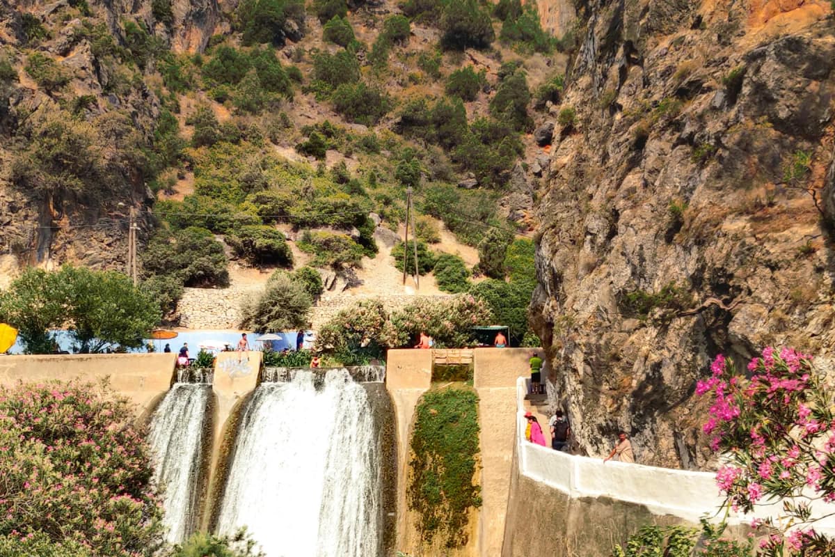 The dam and green river pool at Akchour, the starting point for the waterfall hikes near Chefchaouen