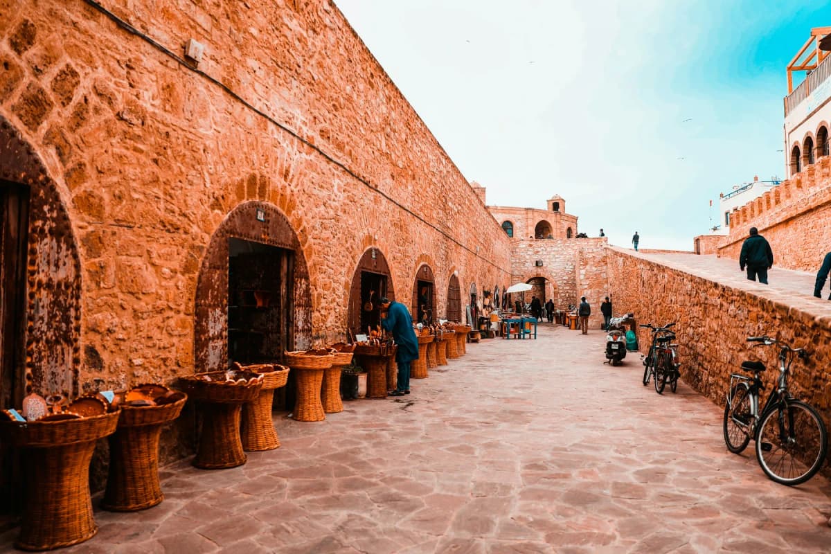 Arched workshops and stalls built into the stone wall below the Skala de la Ville in Essaouira