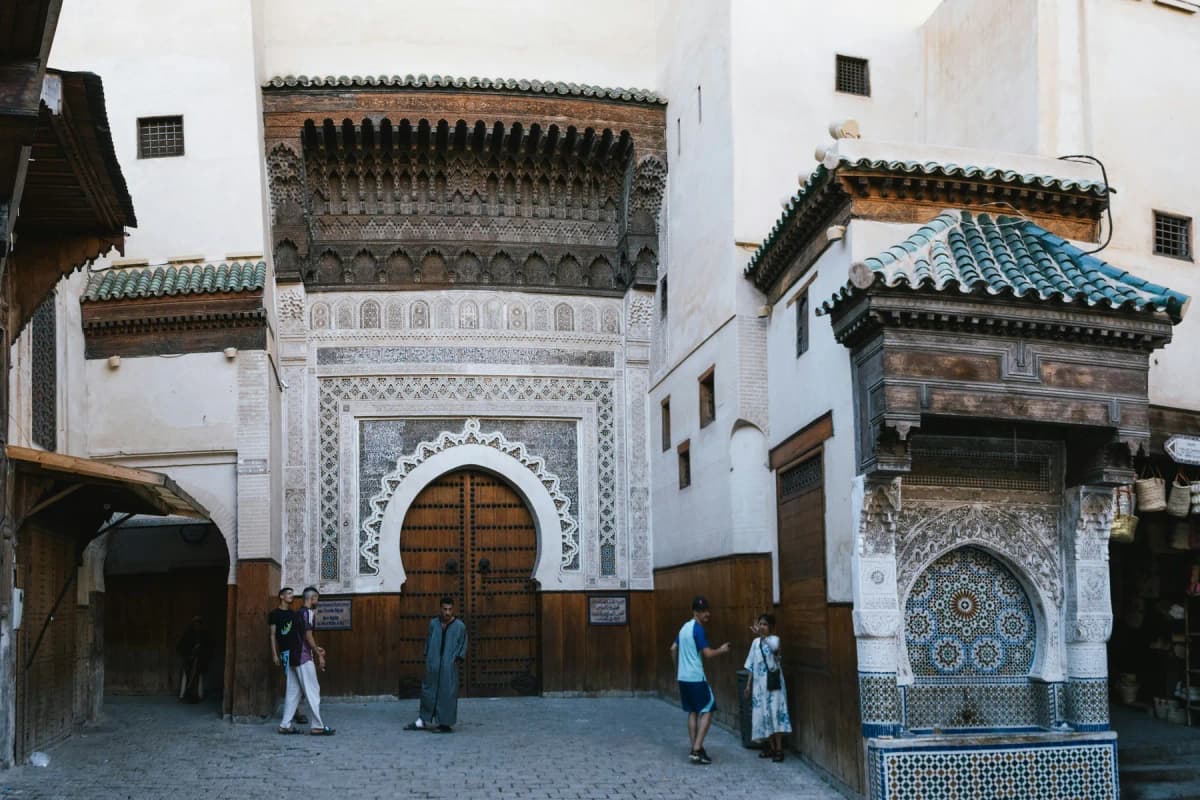 The tiled Nejjarine fountain and carved entrance of the Nejjarine fondouk in the Fes medina