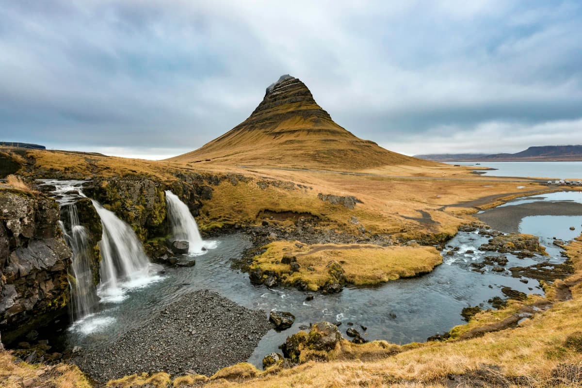 Kirkjufell mountain rising behind the Kirkjufellsfoss waterfalls on the Snæfellsnes Peninsula