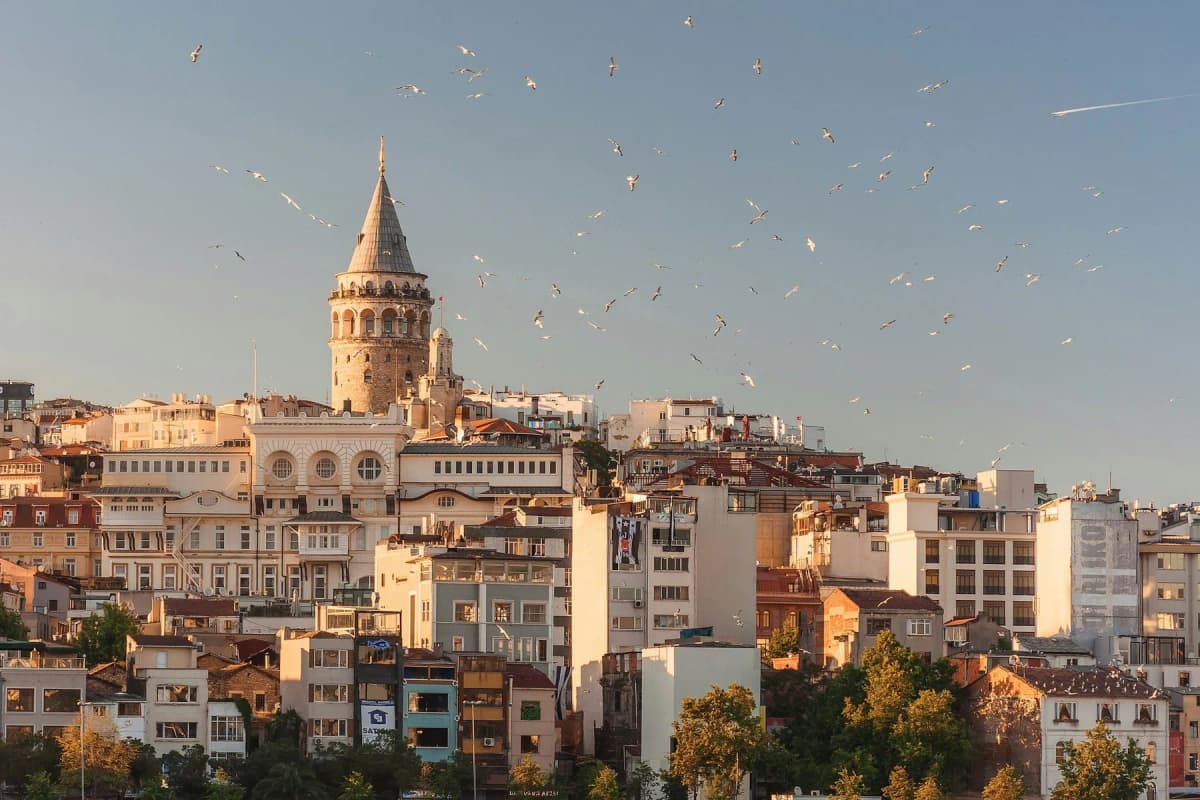 Galata Tower rising above the rooftops of Galata at sunset