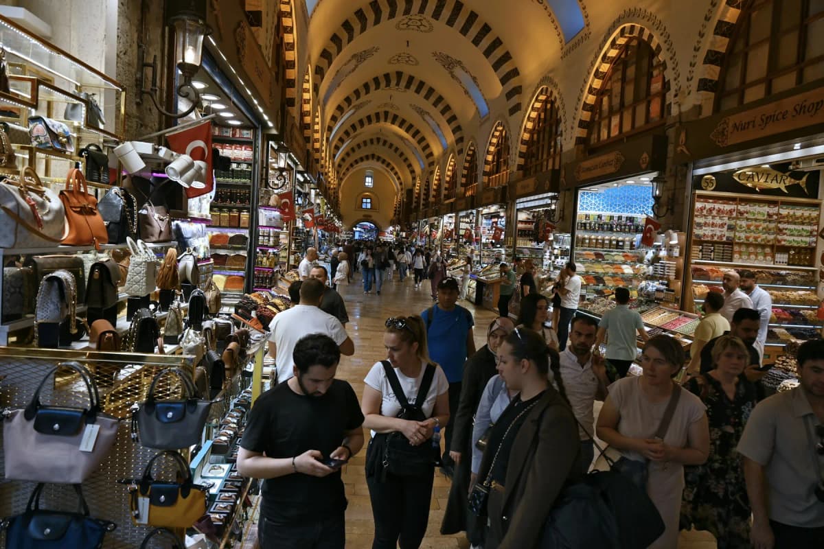 Shoppers under the painted arches of a covered street in Istanbul's Grand Bazaar