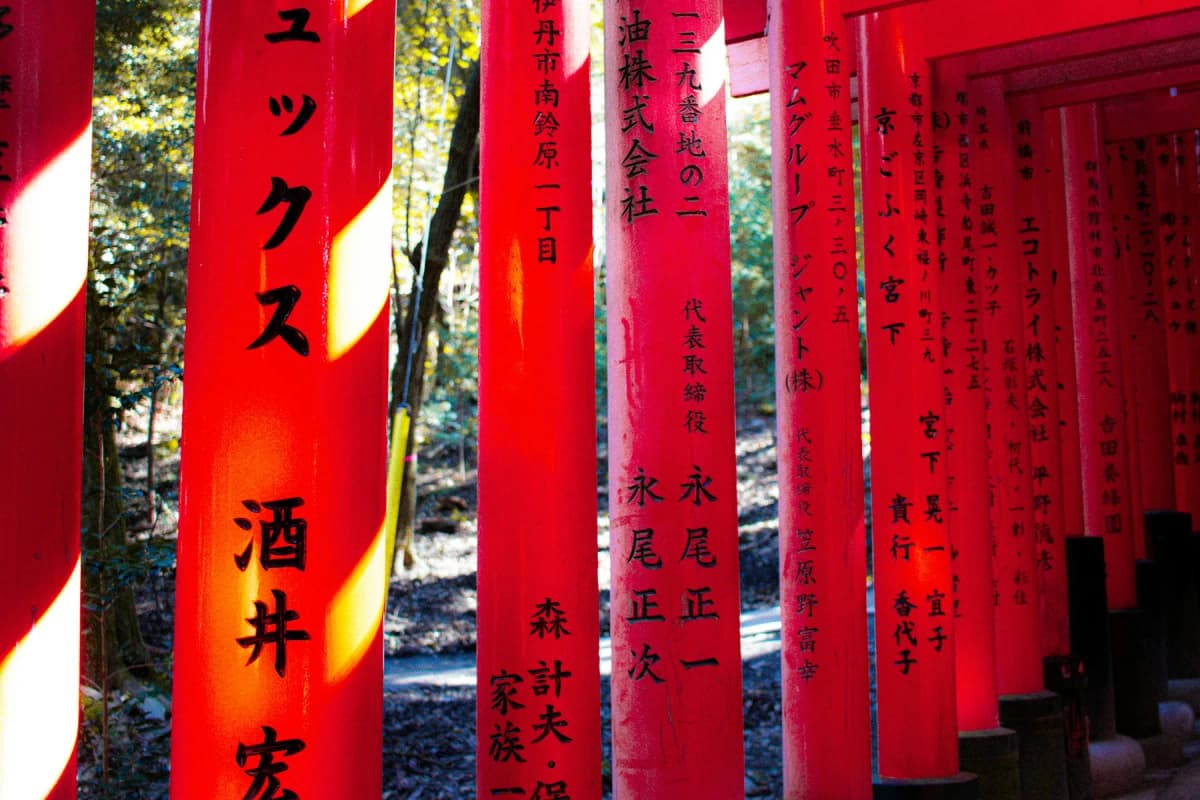 A path through rows of vermilion torii gates at Fushimi Inari Shrine, one of the best things to do in Kyoto