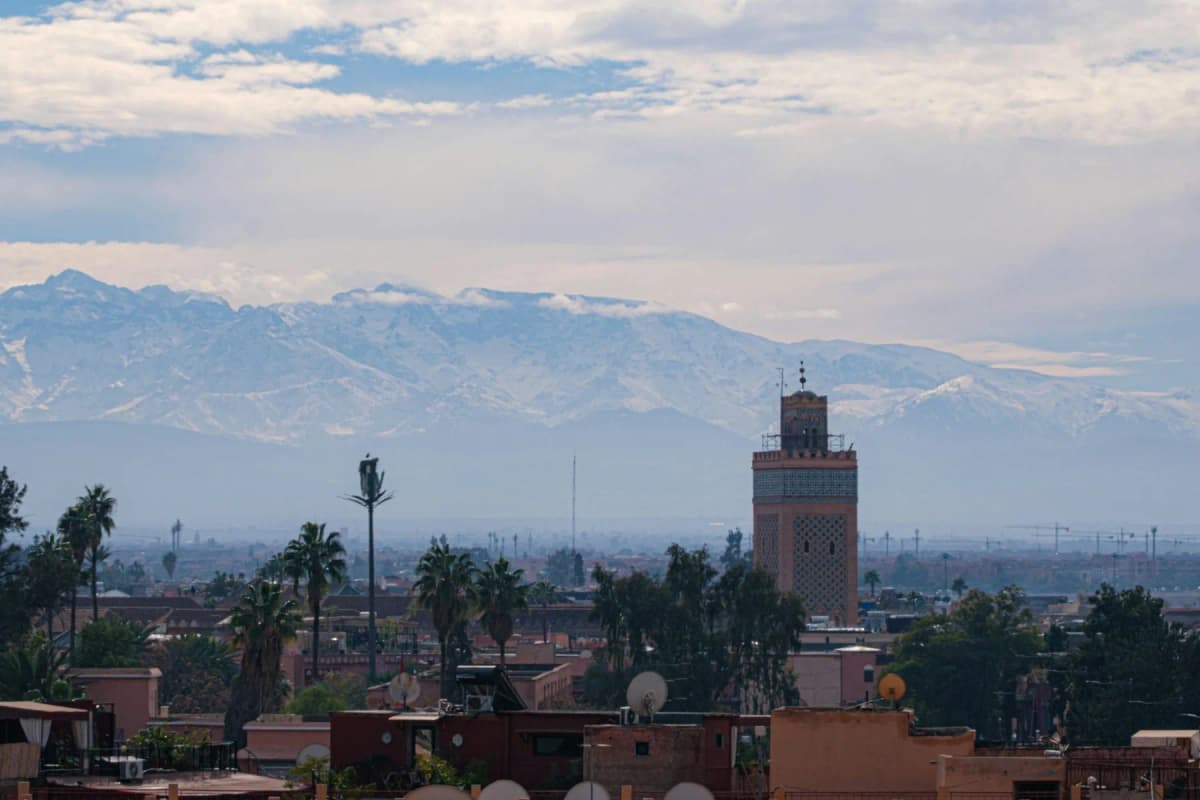 The Koutoubia minaret with the snow-capped Atlas mountains behind