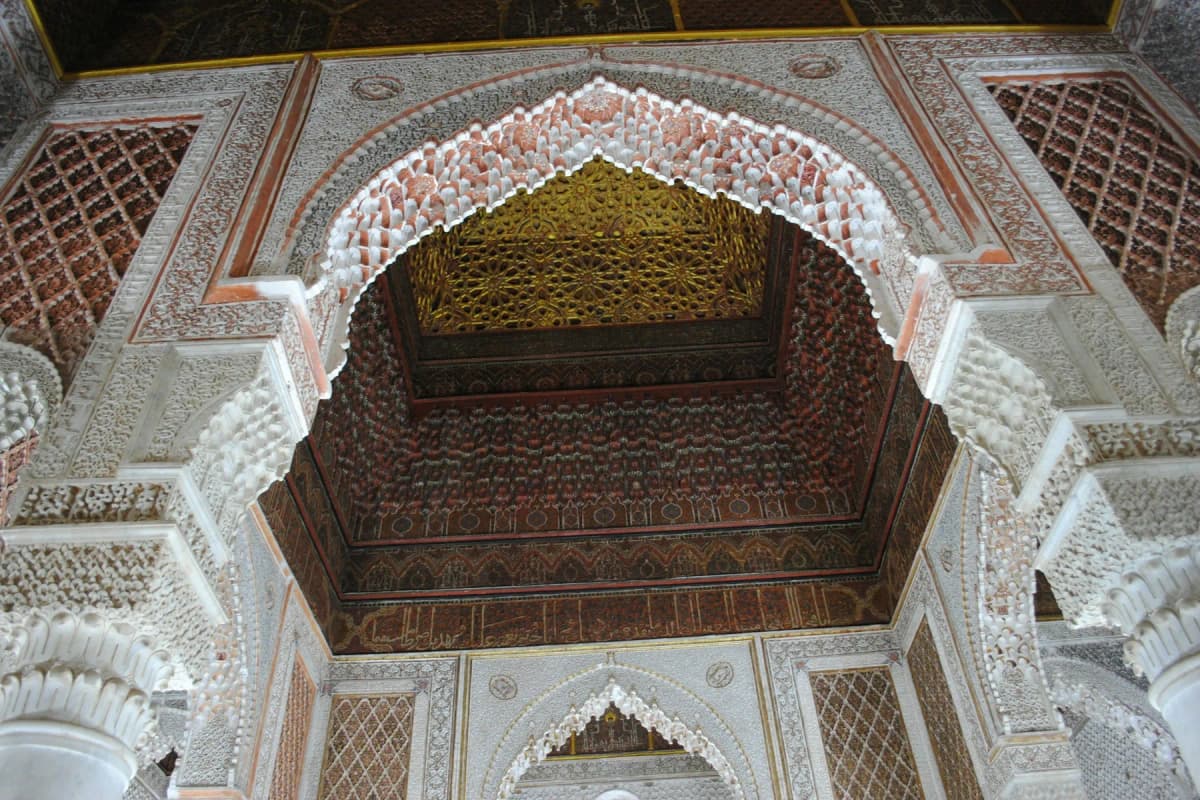 Carved stucco arches and a painted cedar ceiling in Marrakech