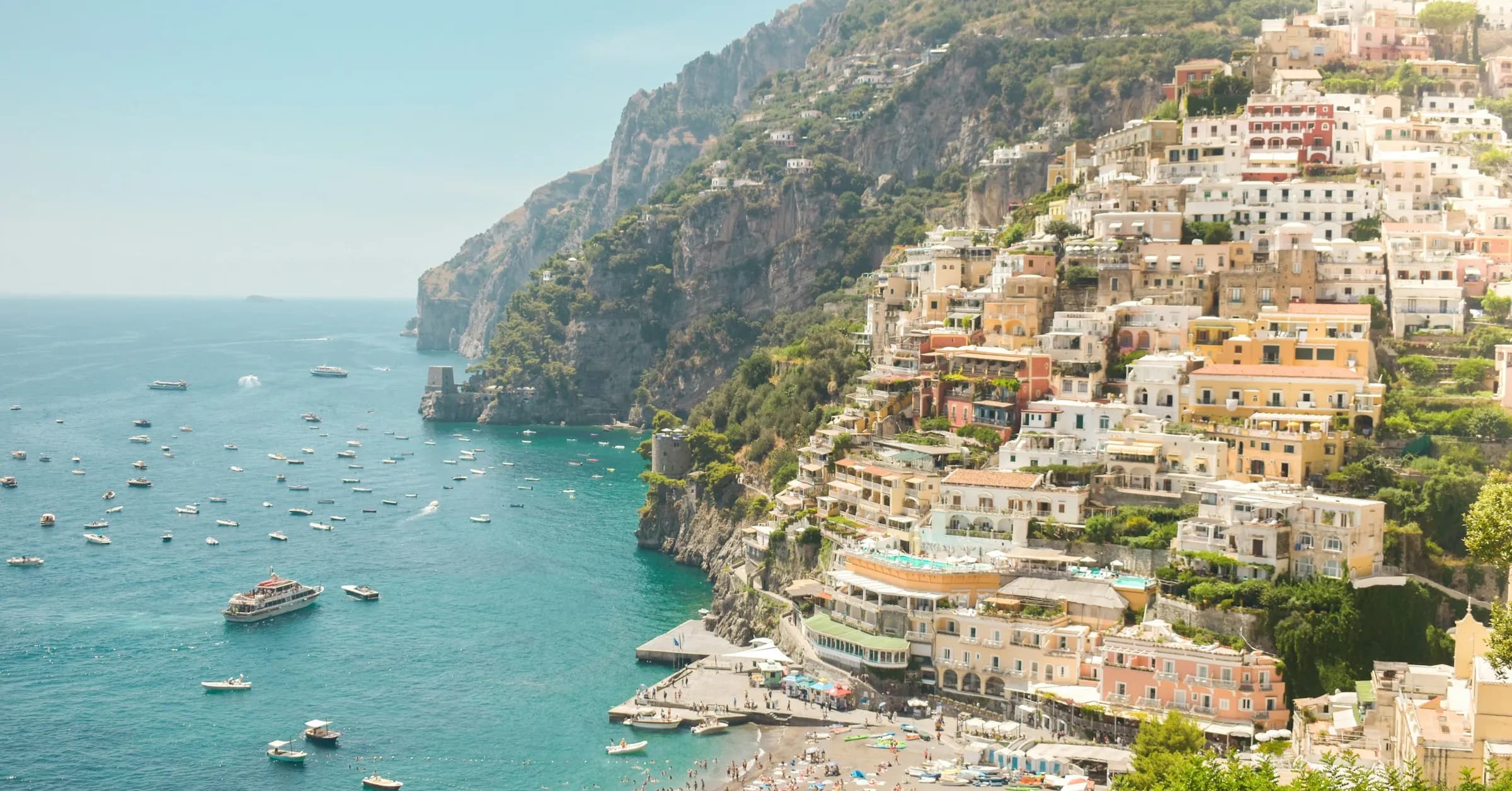Things to do in Positano: pastel houses stacked on the hillside above Spiaggia Grande beach and the sea