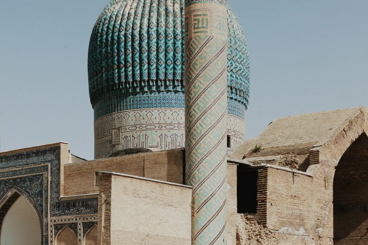 The ribbed turquoise dome and a tiled minaret of the Gur-e-Amir mausoleum in Samarkand